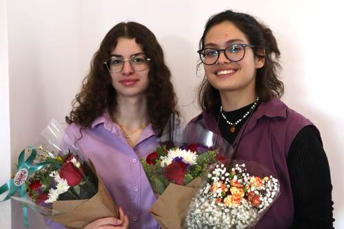 Curators Gaya Shiff and Noor Khalila with flowers