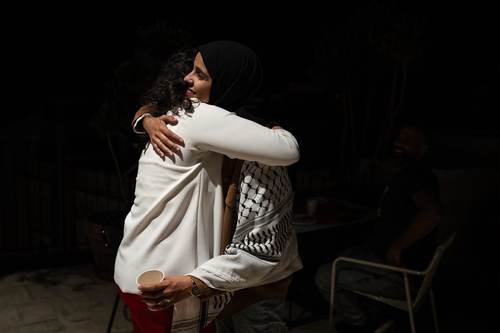 Participants embracing at the book launch
