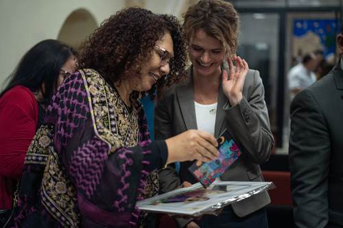 Two women sharing a moment with the book