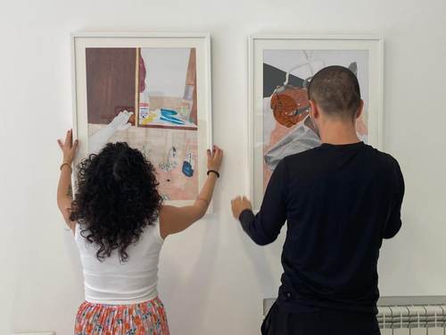 Hanging artwork ahead of the exhibition opening